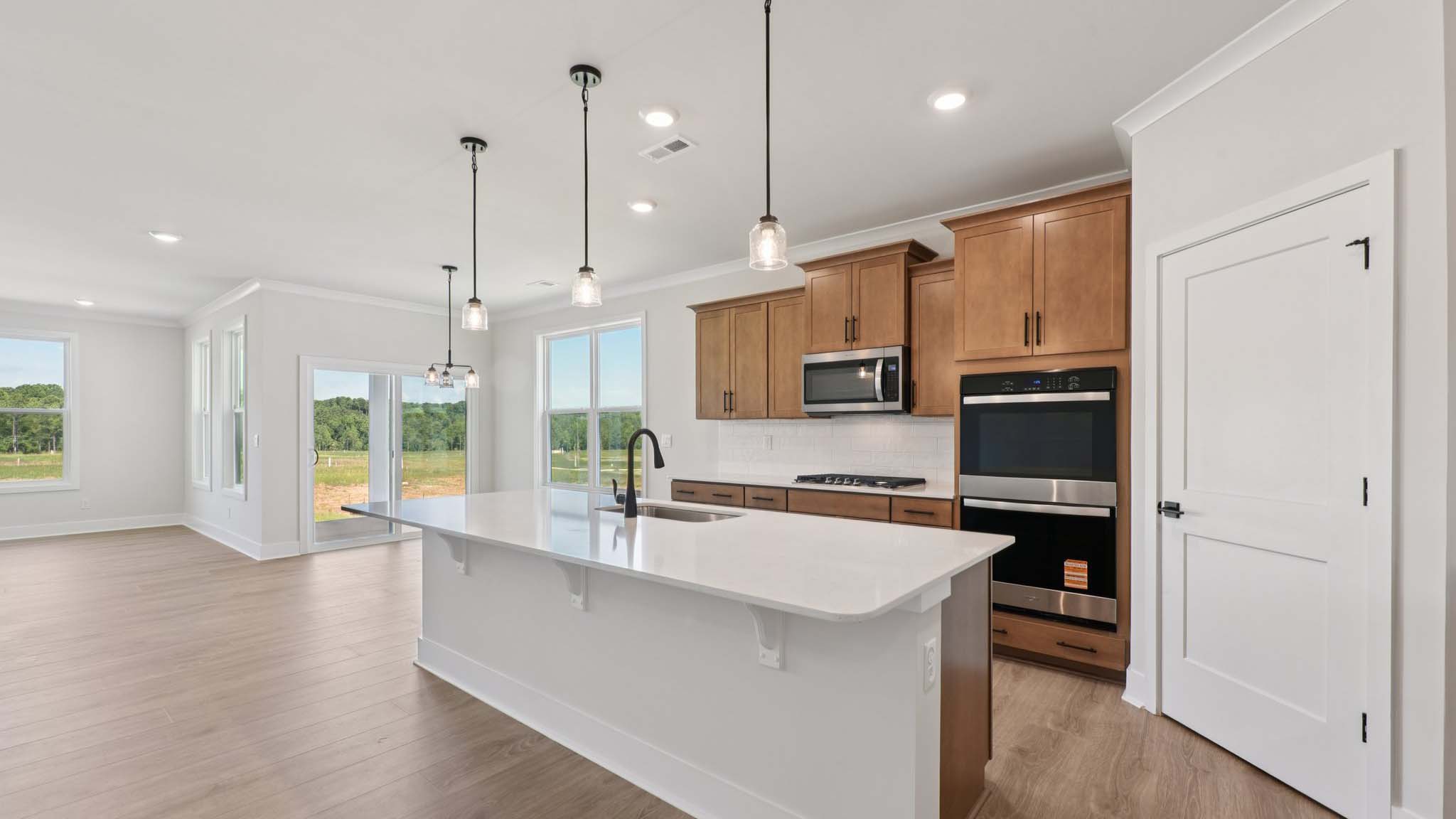 Large kitchen and island with stainless steel appliances
