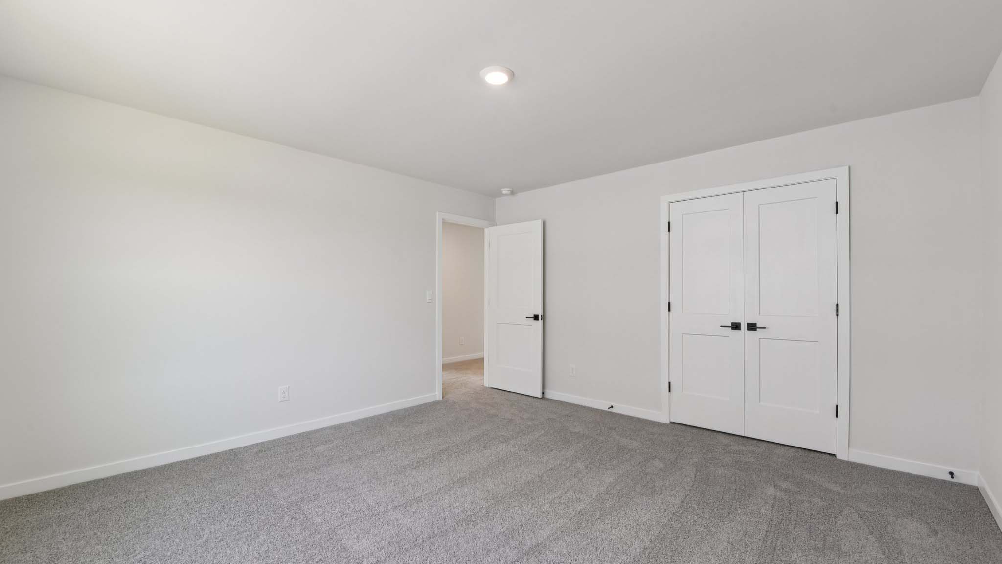 Carpeted bedroom with windows