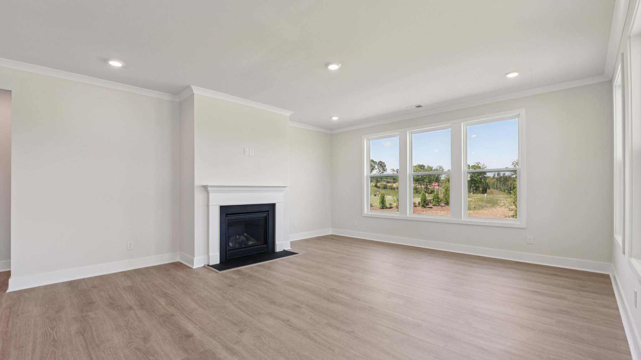 Open living room with windows and fireplace