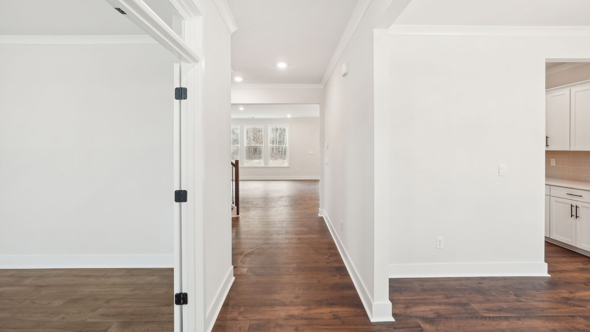 welcoming foyer with view of front door, dining room and flex office space