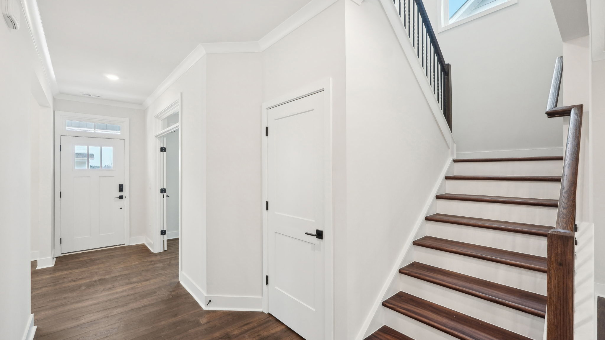 welcoming foyer with view of front door, dining room and flex office space