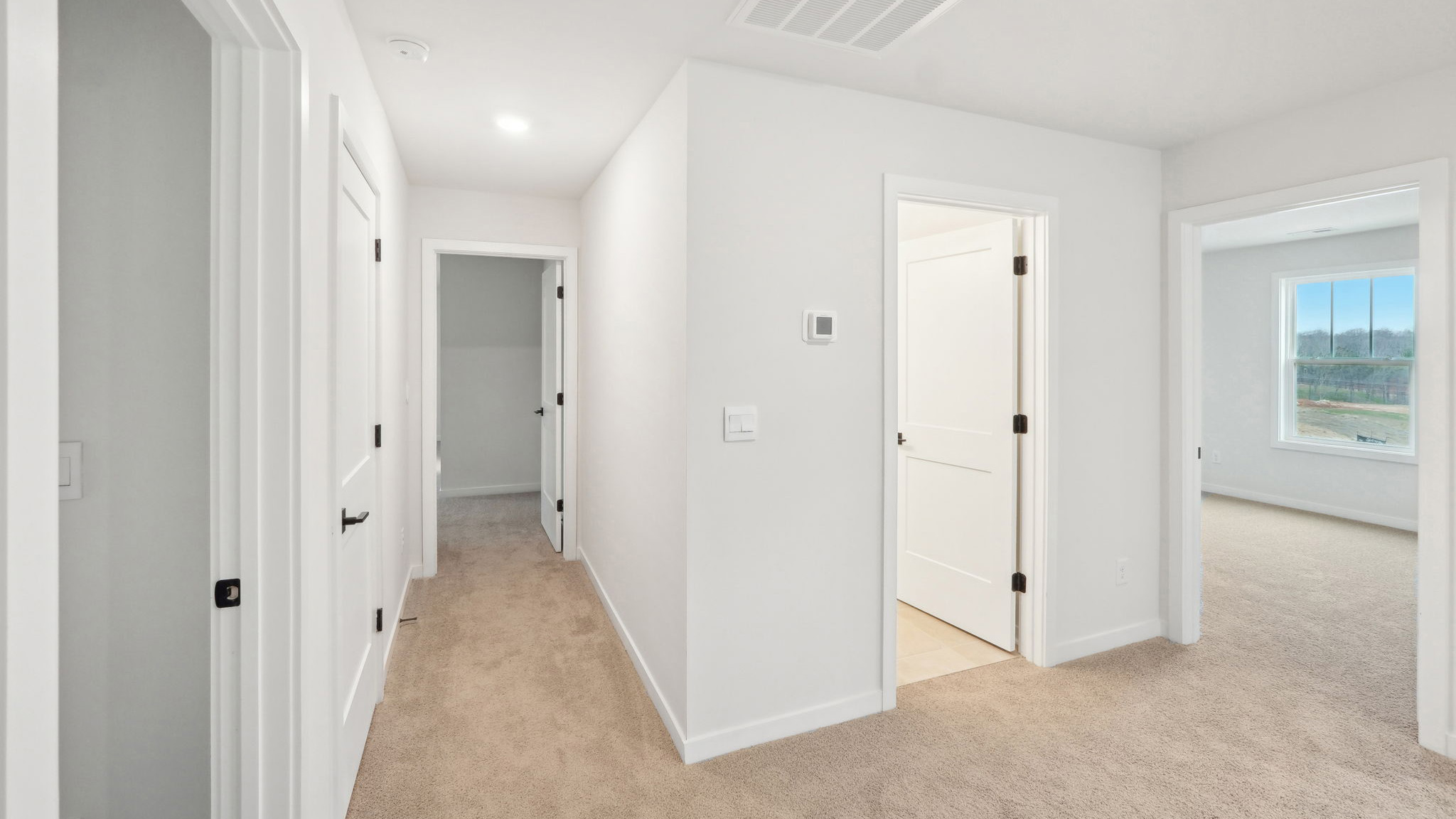 carpeted bedroom with large window