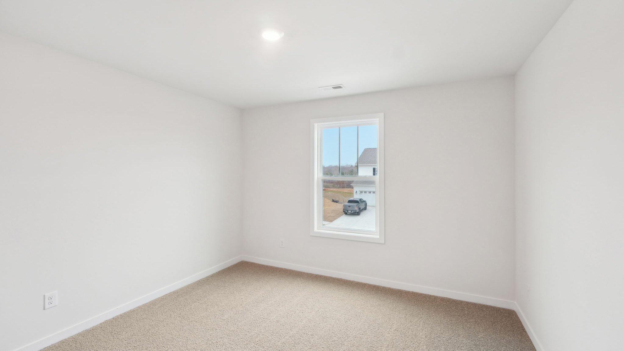 carpeted bedroom with large window