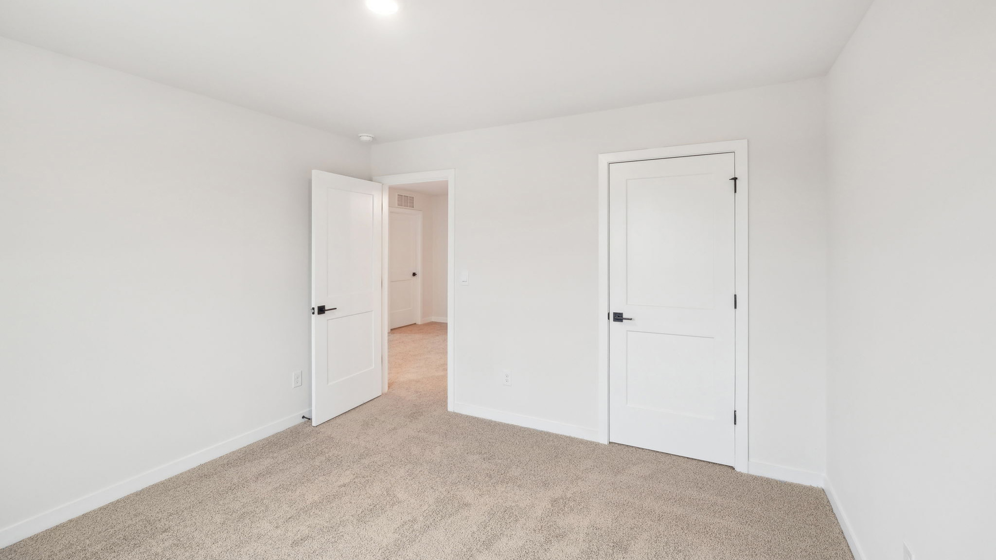 carpeted bedroom with large window