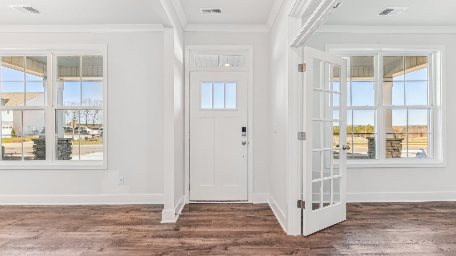 welcoming foyer with view of front door, dining room and flex office space