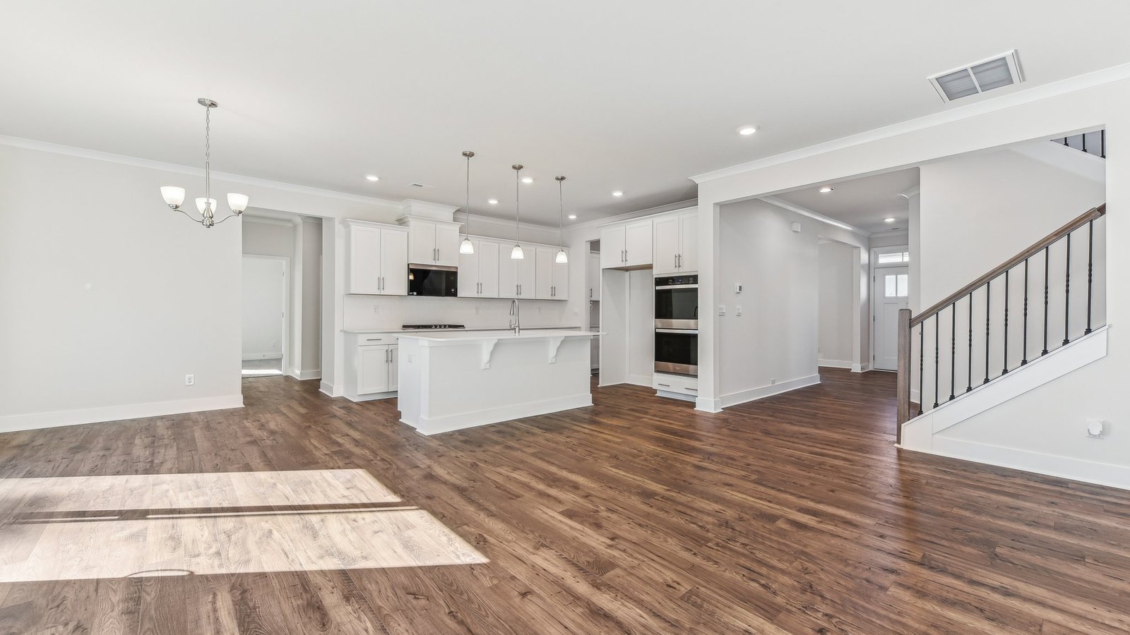 open concept living area with 3 large windows and fireplace