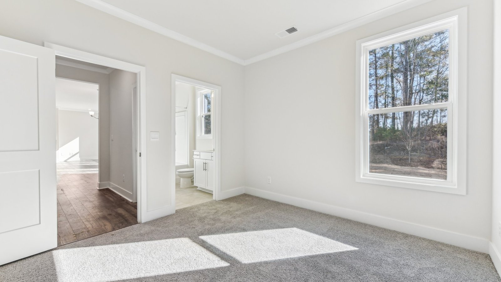 carpeted bedroom with large window