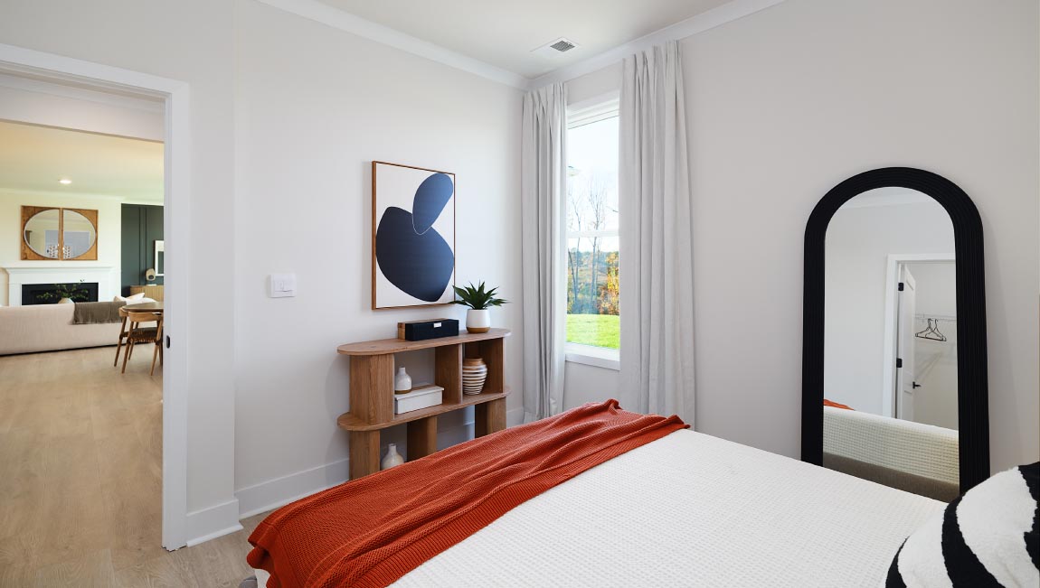 Large carpeted bedroom with three windows