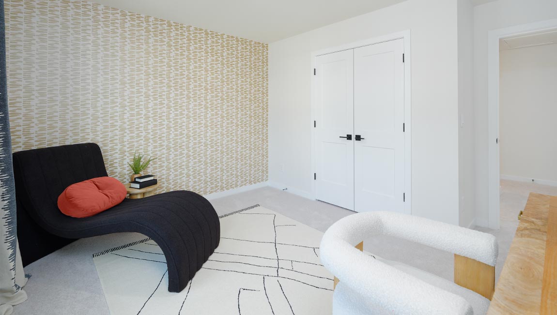 Large carpeted bedroom with three windows