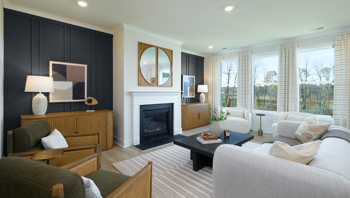 Open family room with three small windows and fireplace