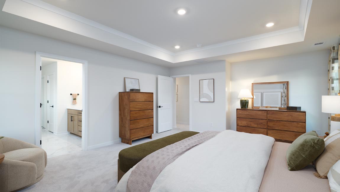 Primary carpeted bedroom with windows