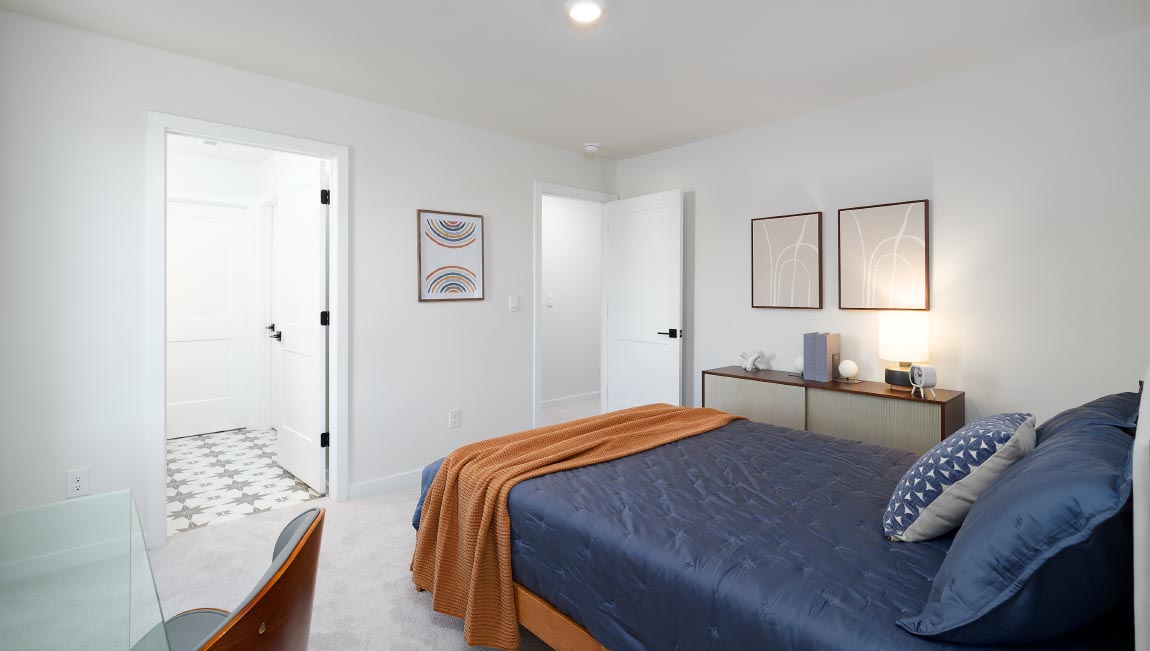 Large carpeted bedroom with three windows