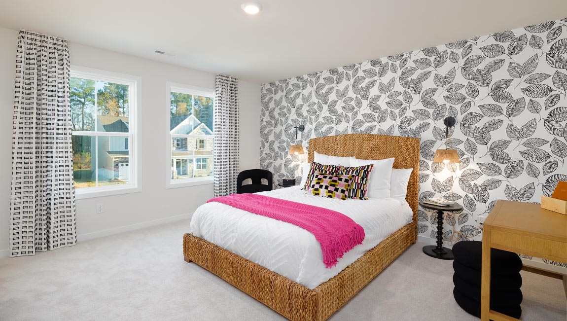 Large carpeted bedroom with three windows
