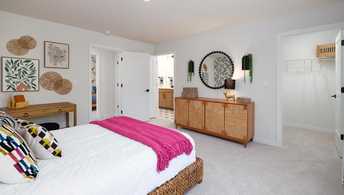 Large carpeted bedroom with three windows