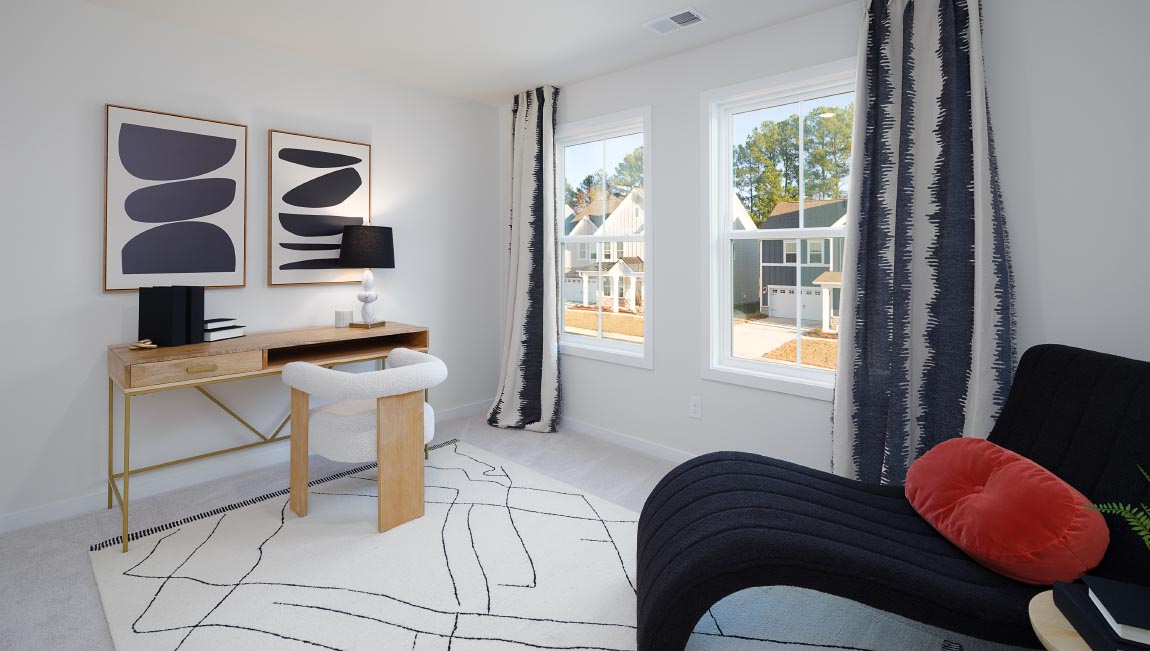Large carpeted bedroom with three windows