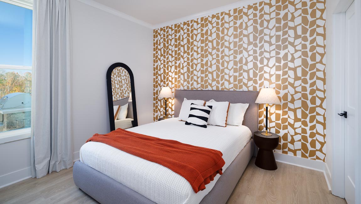 Large carpeted bedroom with three windows