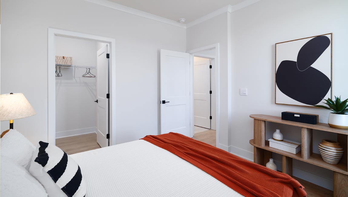 Large carpeted bedroom with three windows