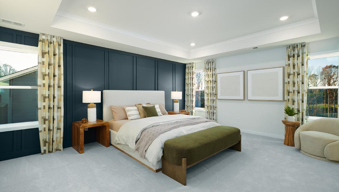 Primary carpeted bedroom with large windows