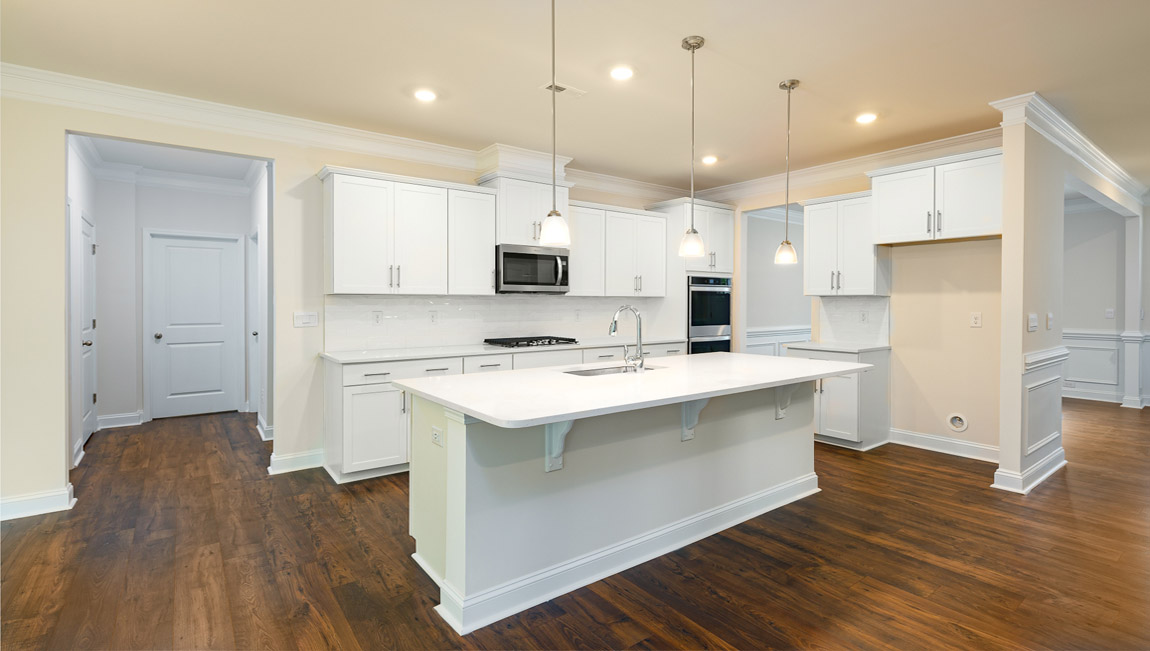 Kitchen and island, white counters and cabinets