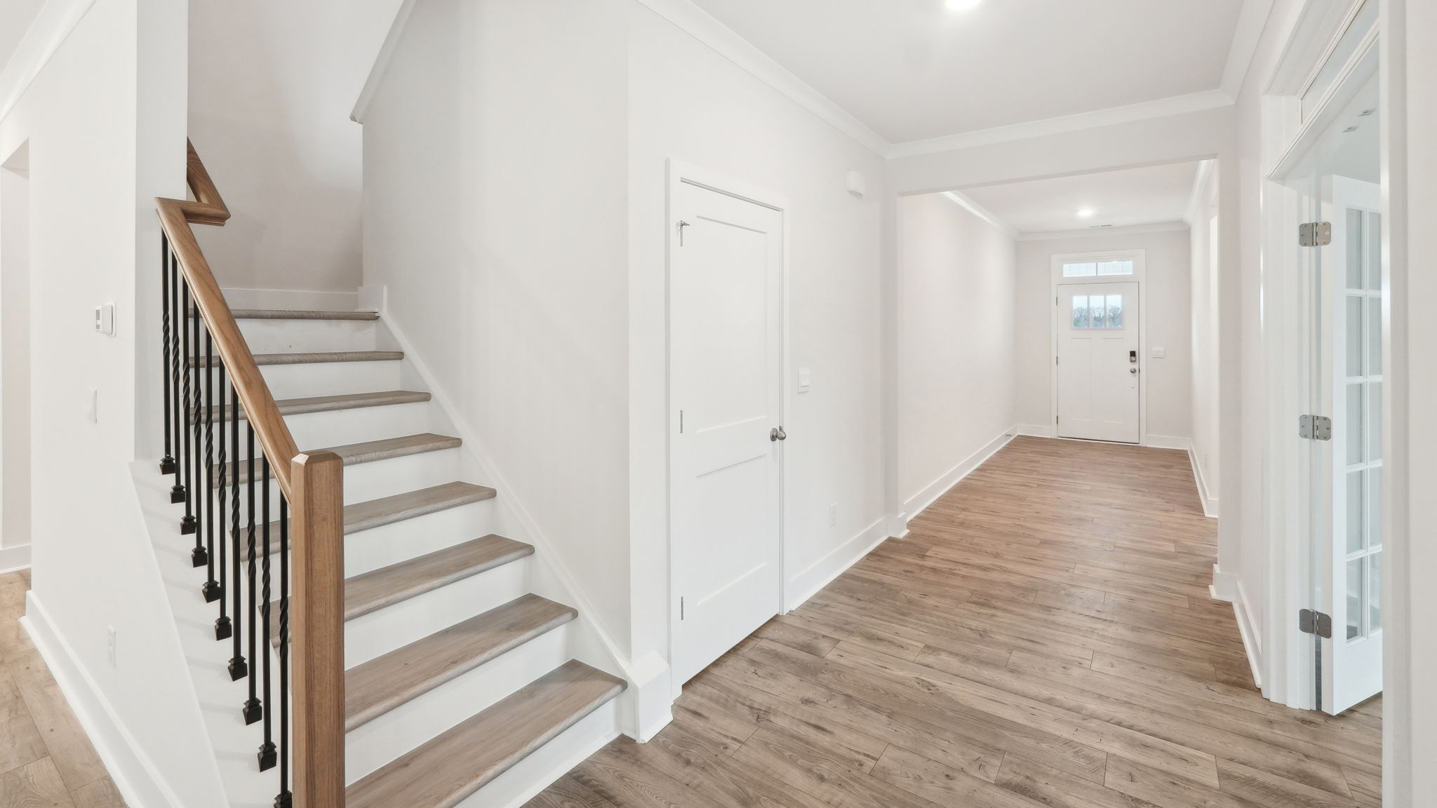 Welcoming foyer with view of stairs