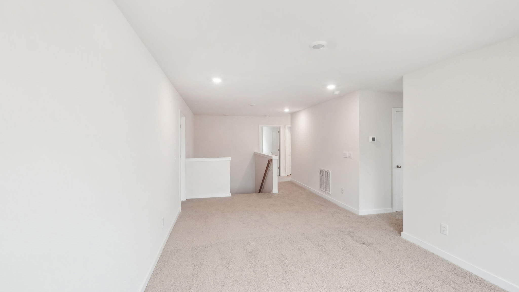 Carpeted bedroom with windows
