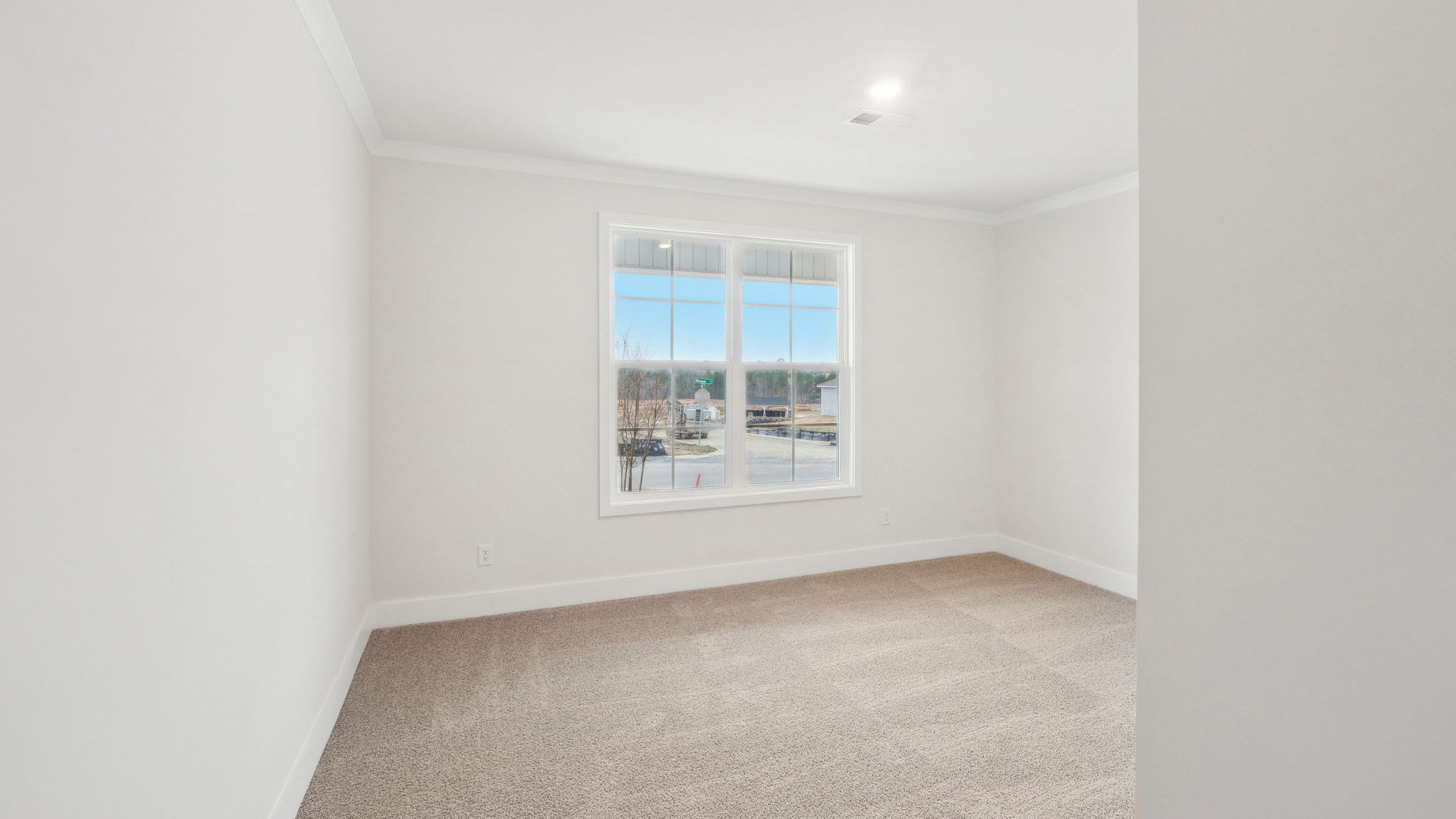 Carpeted bedroom with windows
