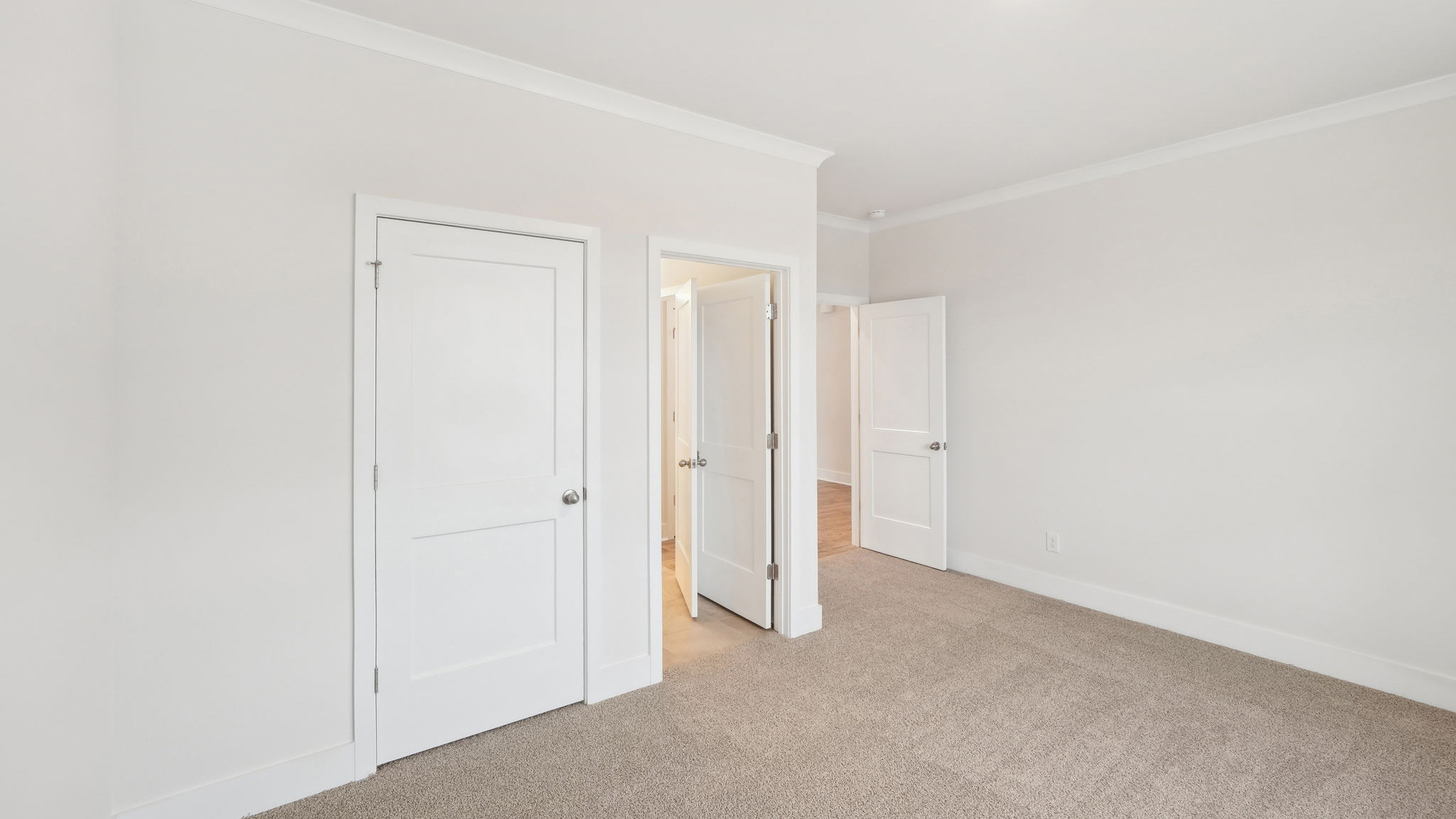 Carpeted bedroom with windows