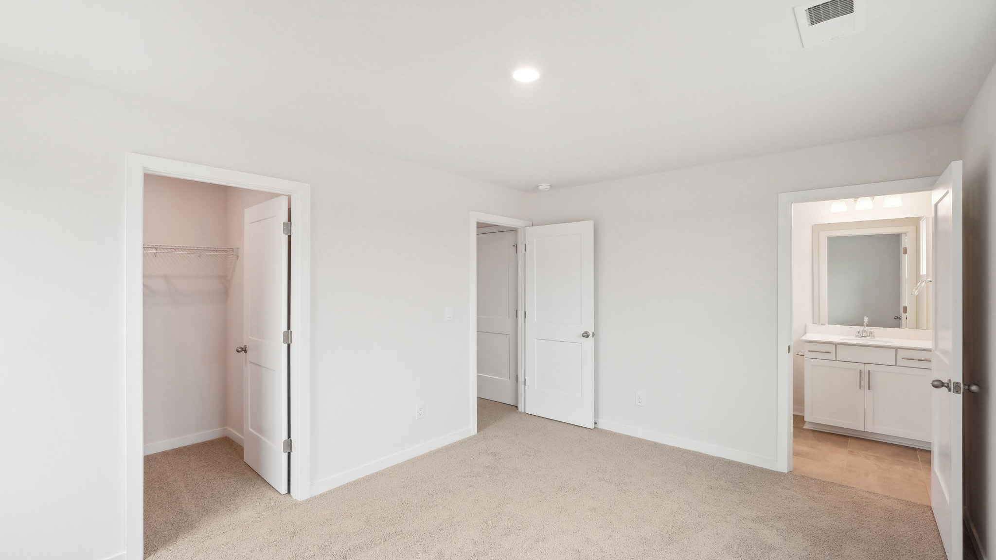 Carpeted bedroom with windows