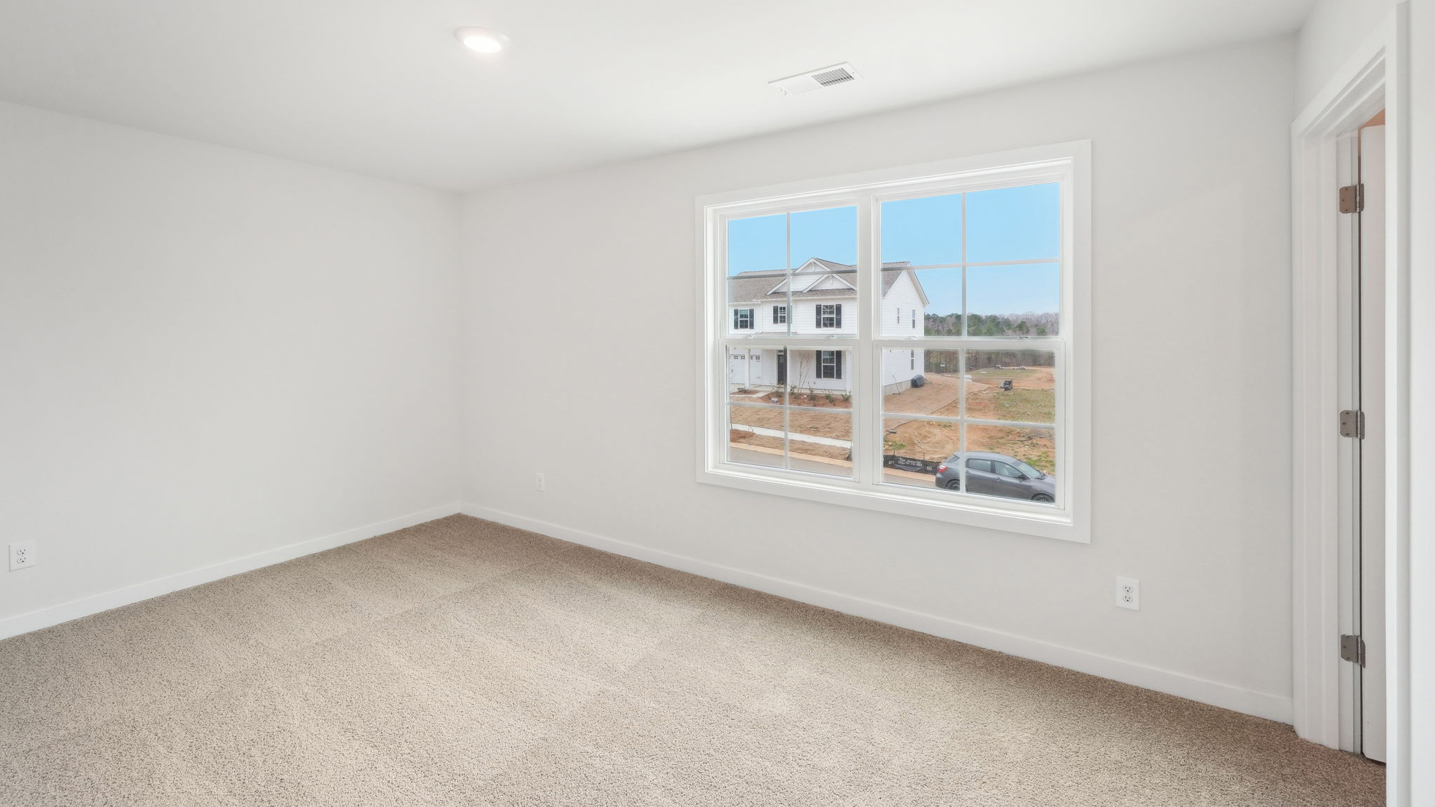 Carpeted bedroom with windows