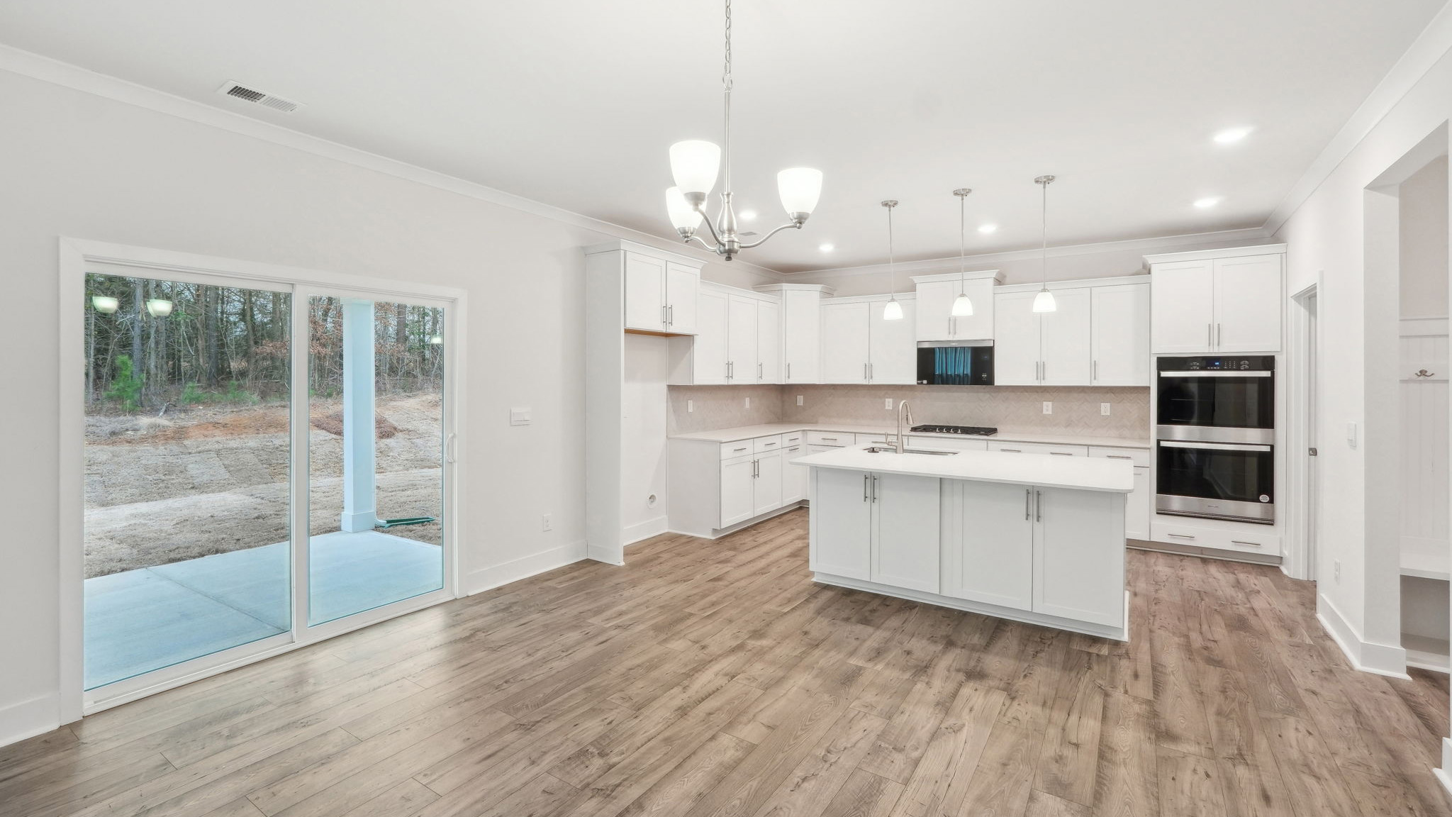 Living room beside kitchen with large windows