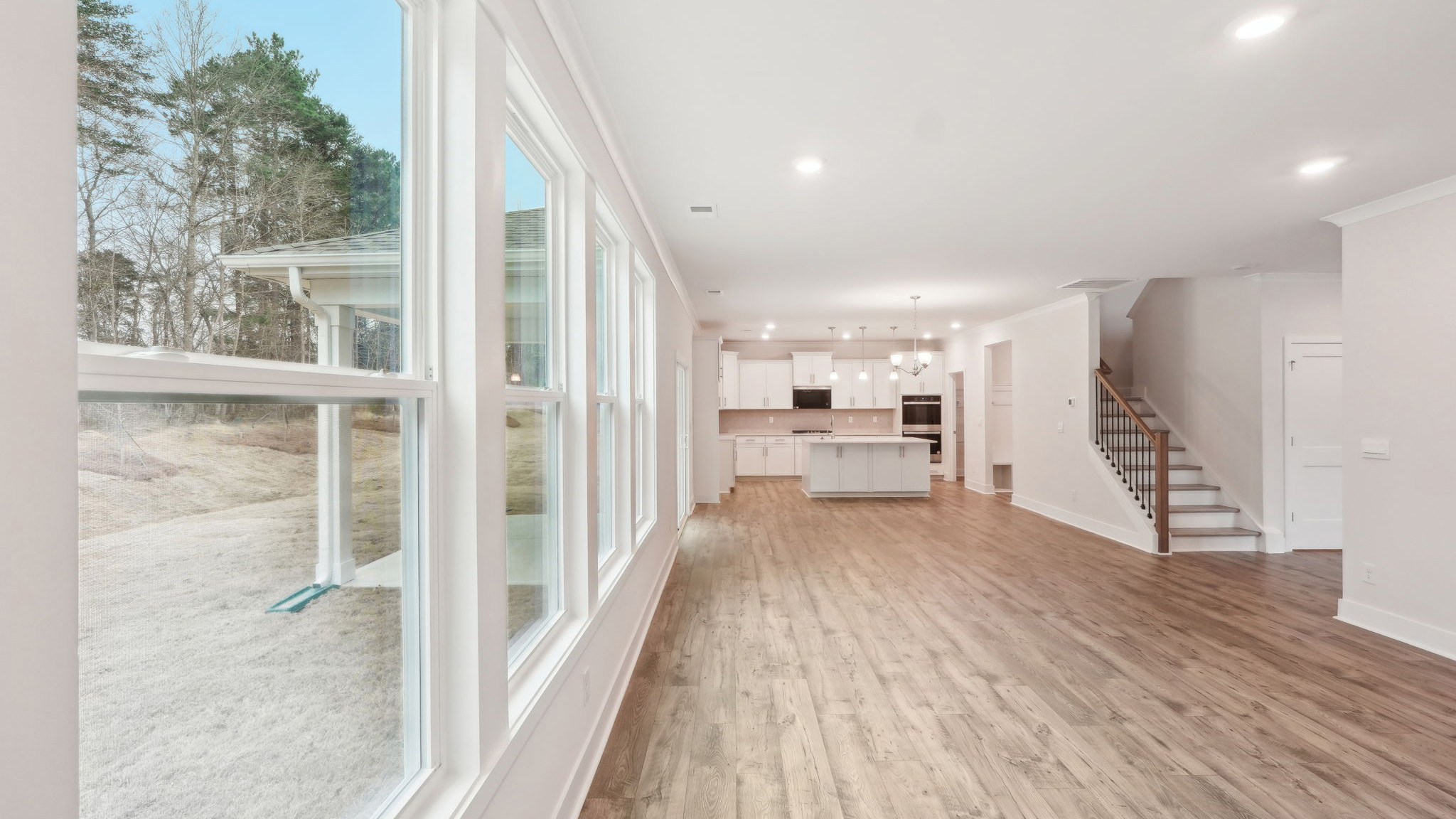 Living room beside kitchen with large windows