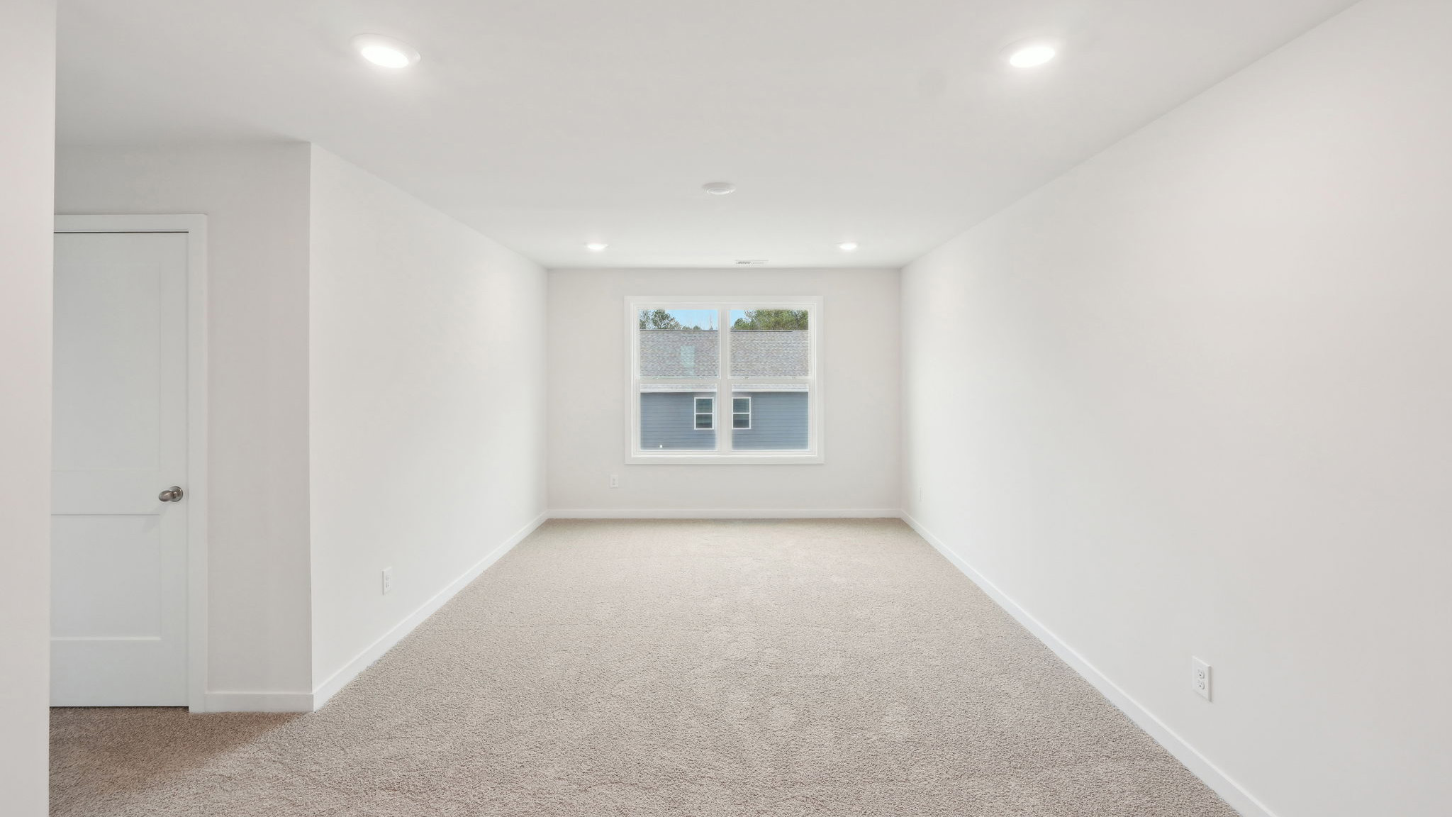 carpeted bedroom with large window