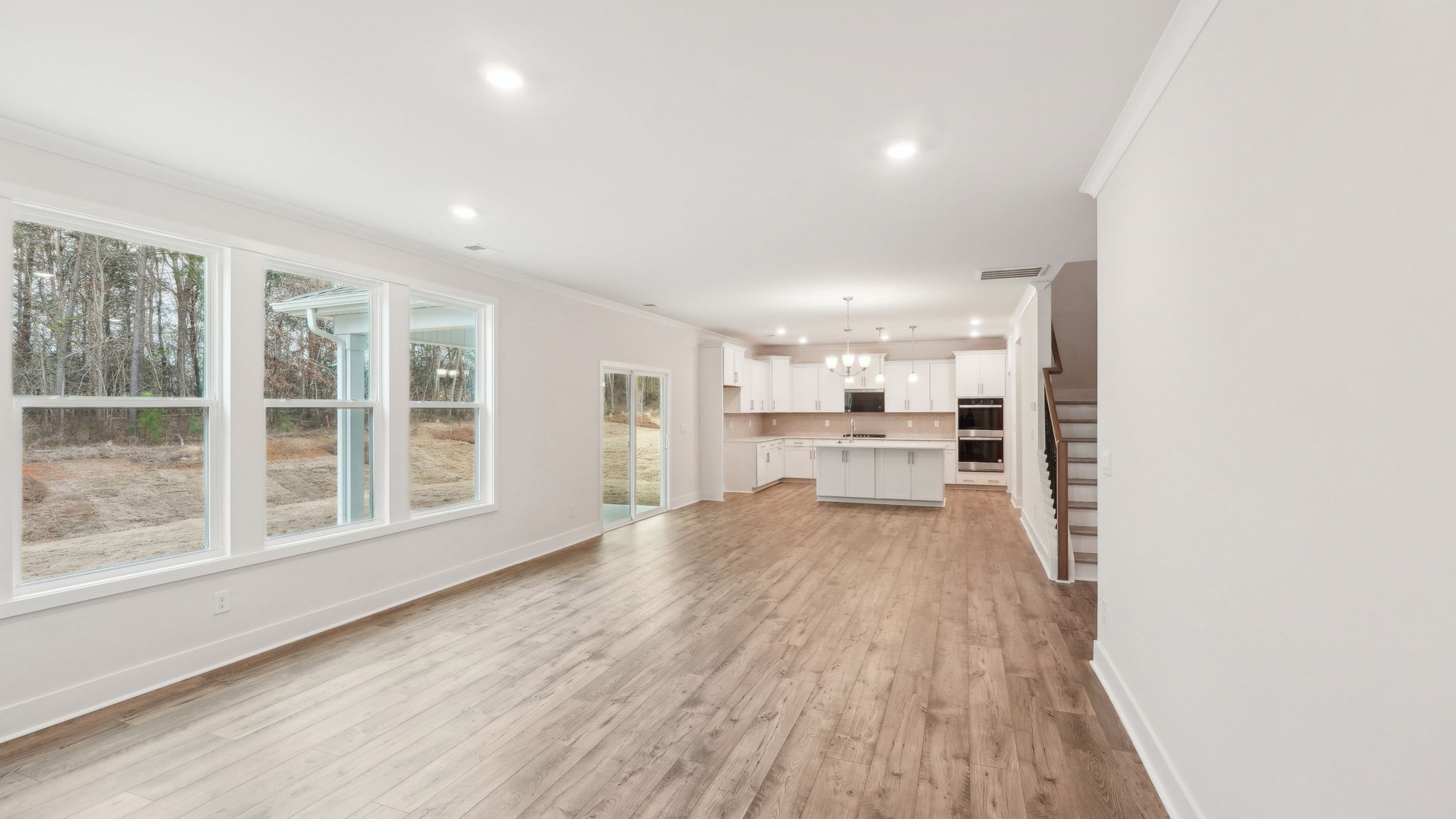 Living room beside kitchen with large windows