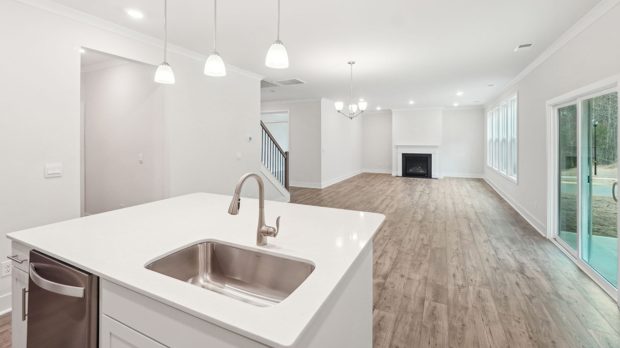 Kitchen and island with white cabinets and stainless steel appliances