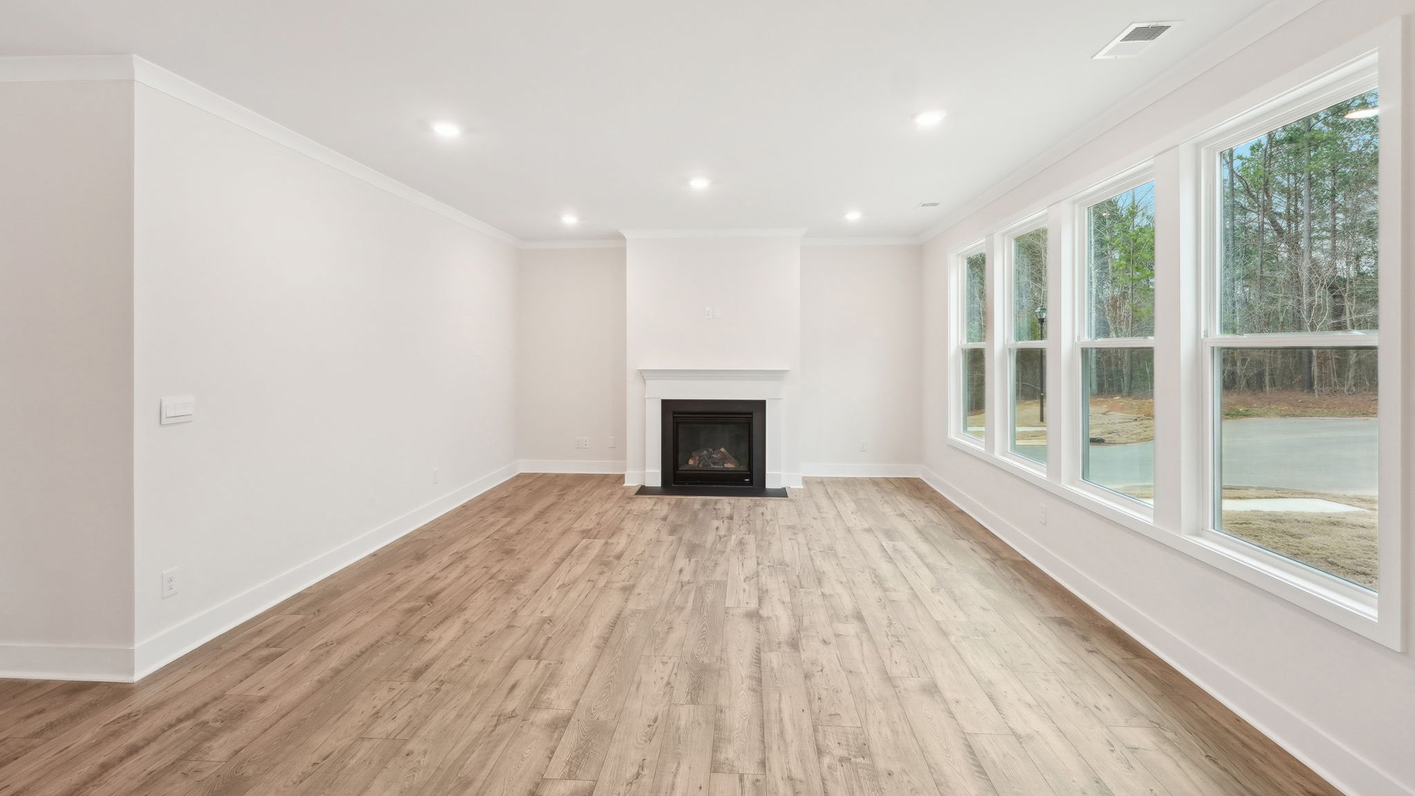 Living room beside kitchen with large windows