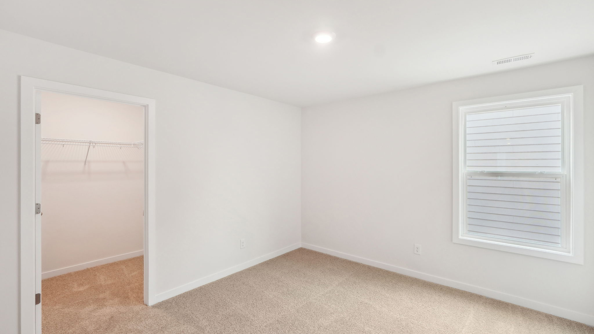 carpeted bedroom with large window