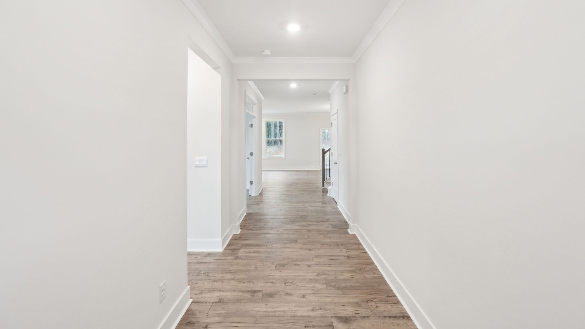 Kitchen and island with white cabinets and stainless steel appliances