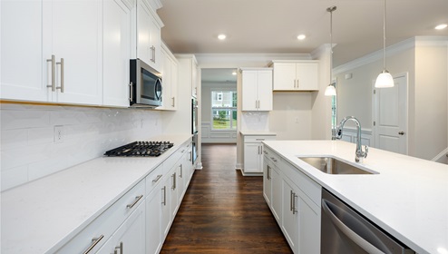 Kitchen and island, white counters and cabinets