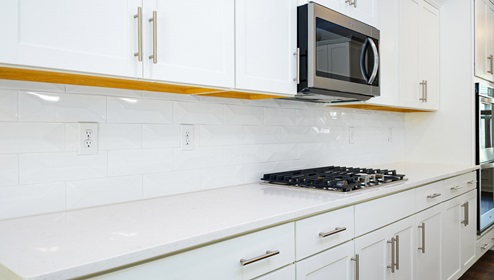 Kitchen and island, white counters and cabinets