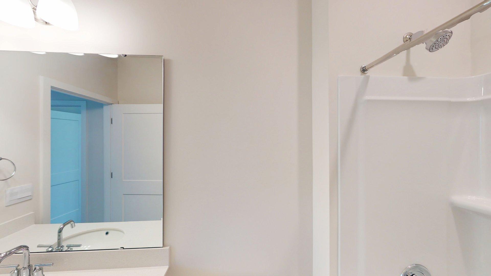 Bathroom with white cabinets and tub shower combination