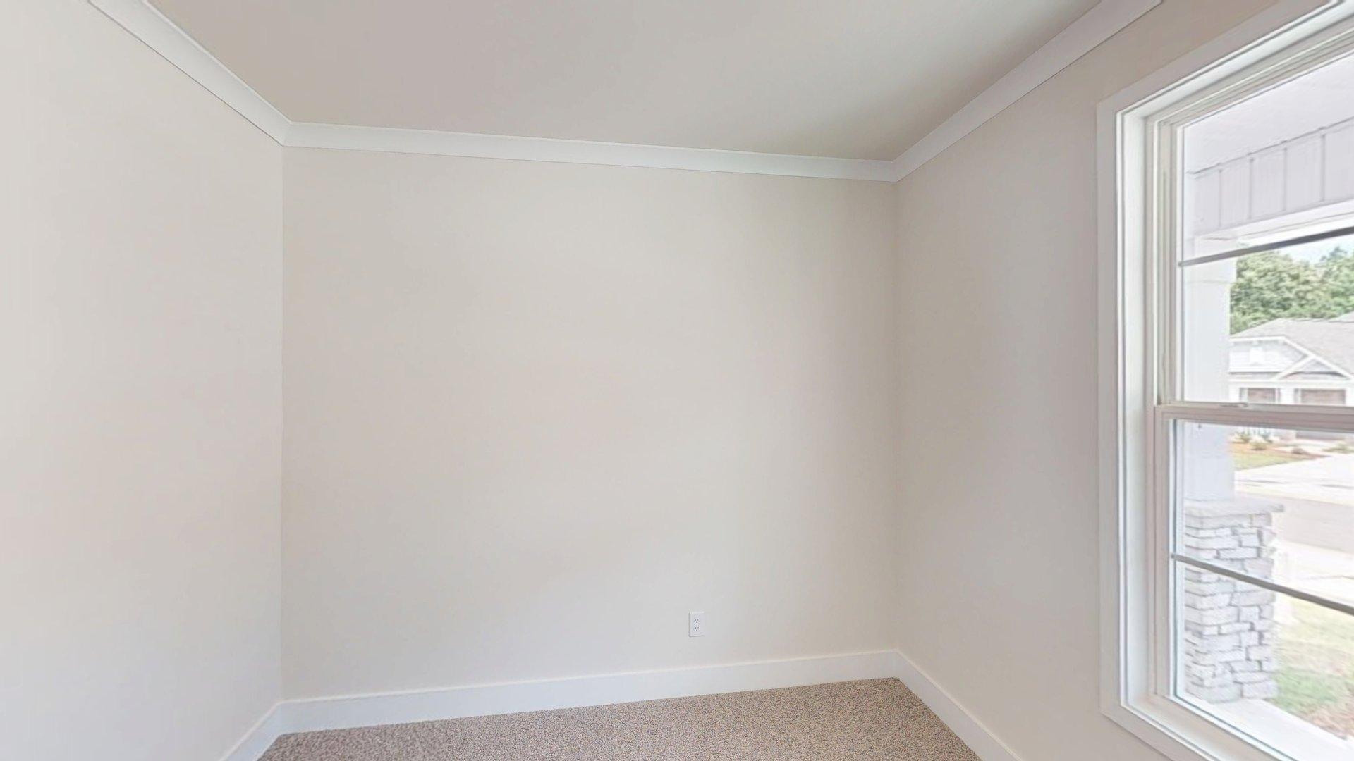 Carpeted bedroom with large windows