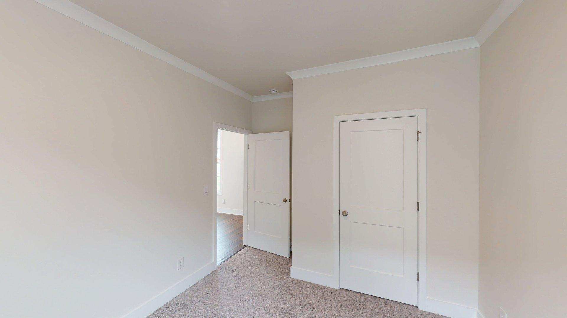 Carpeted bedroom with large windows