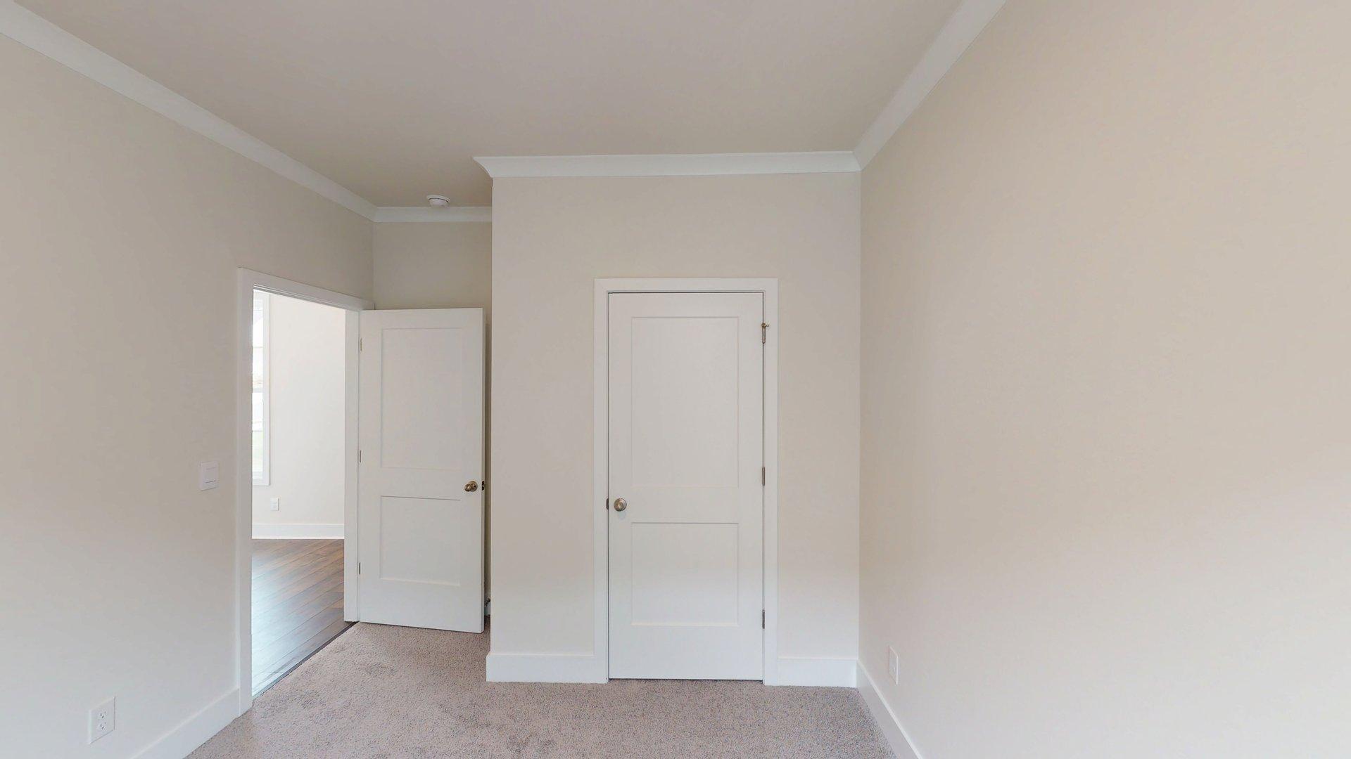 Carpeted bedroom with large windows