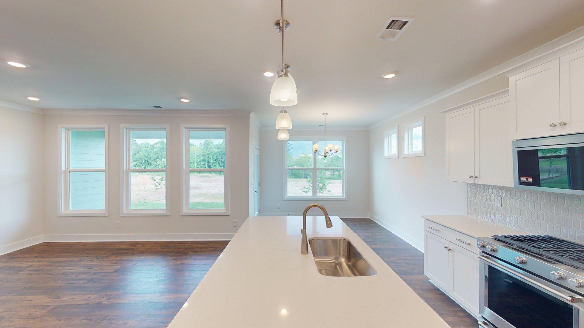 Kitchen and Island with white cabinets and stainless steel appliances