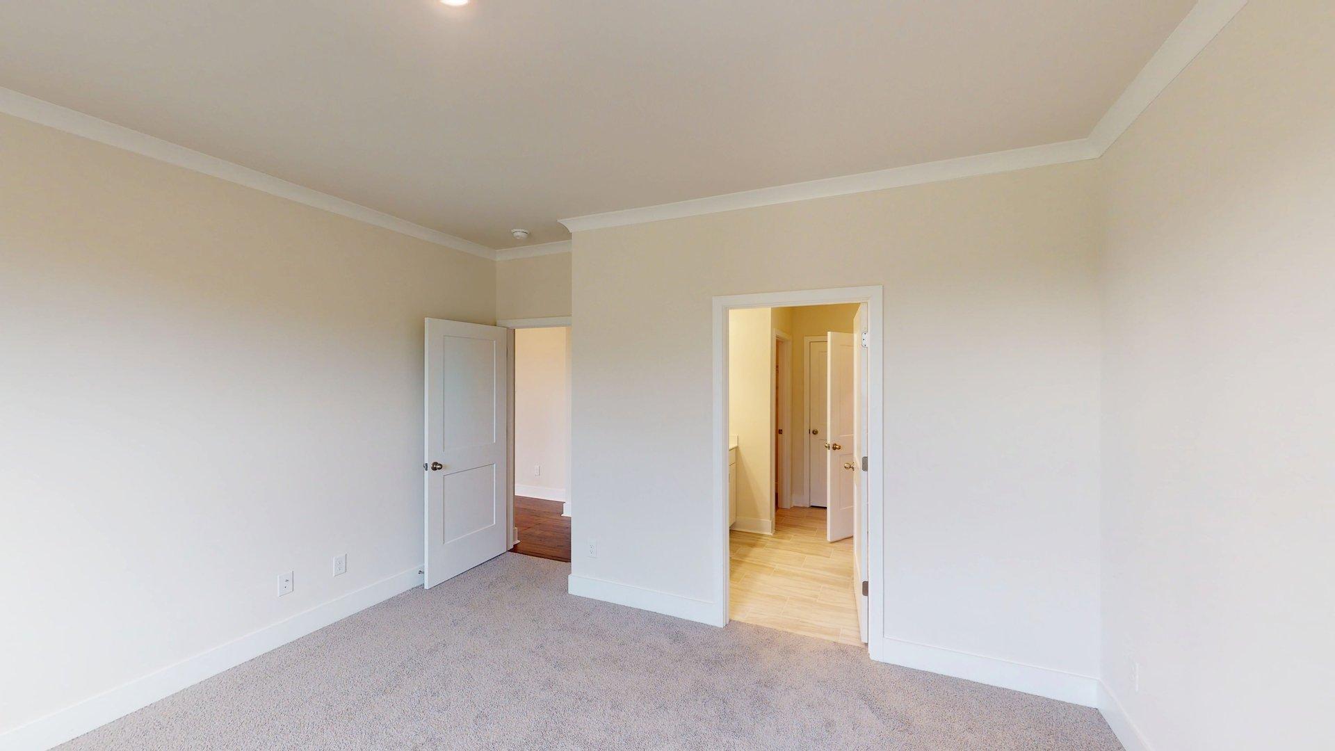 Carpeted bedroom with large windows