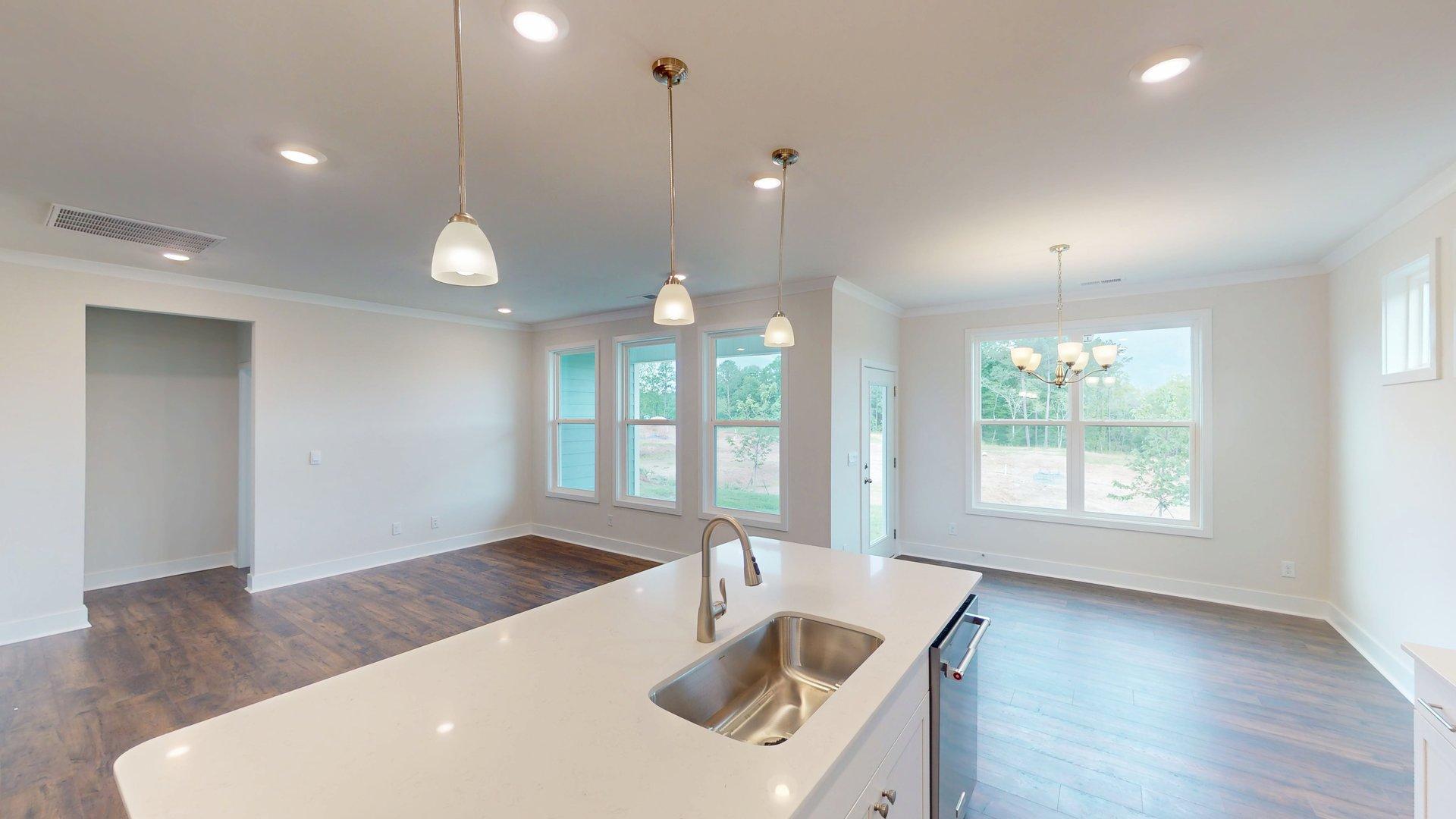 Kitchen and Island with white cabinets and stainless steel appliances