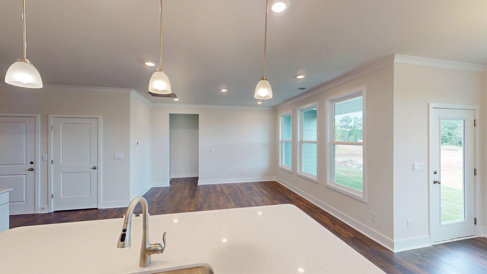 Kitchen and Island with white cabinets and stainless steel appliances