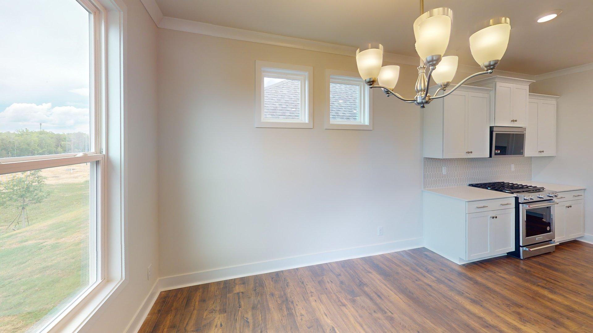 Dining area off the kitchen with large windows