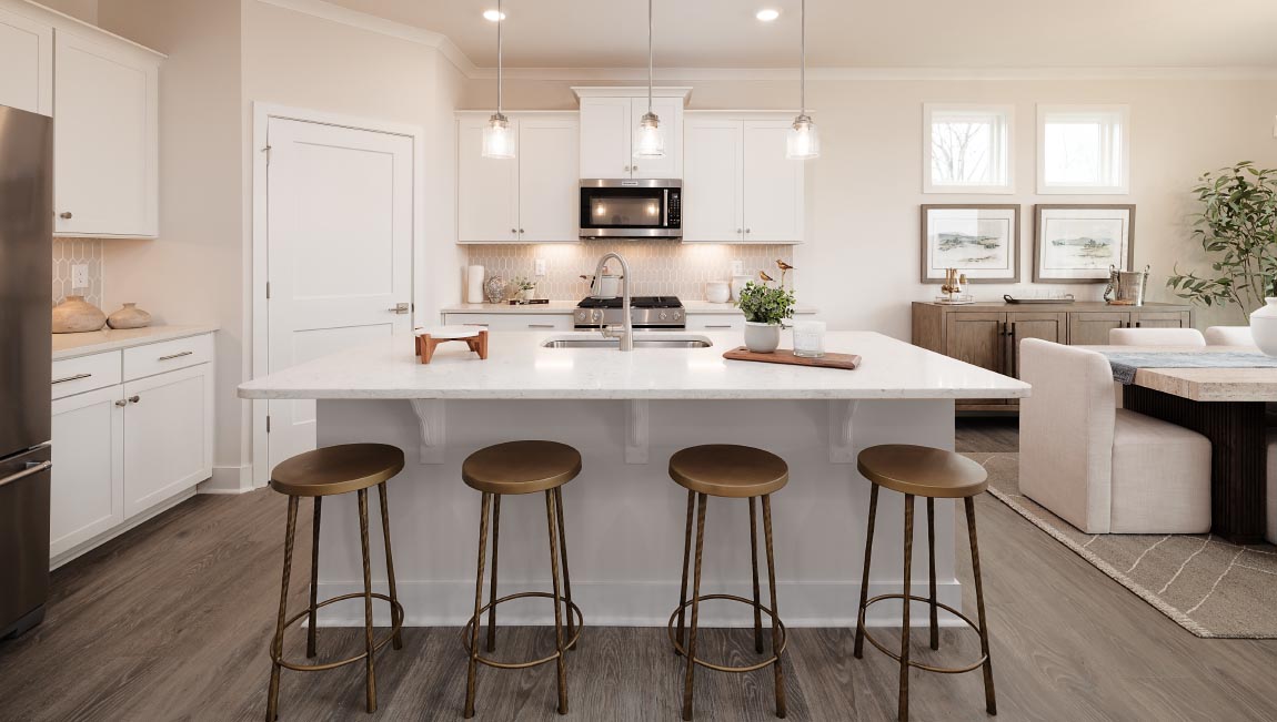 Kitchen and island with white cabinets and stainless steel appliances