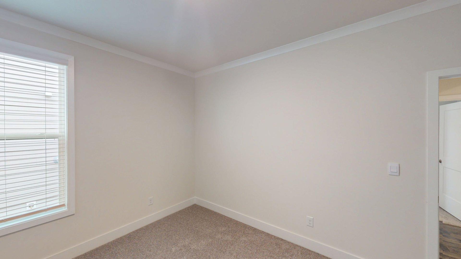 Carpeted bedroom with large window